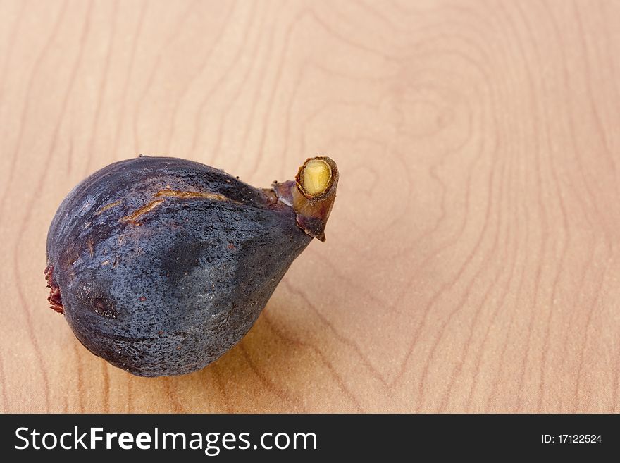 Ripe fruits of a fig on a wooden table.