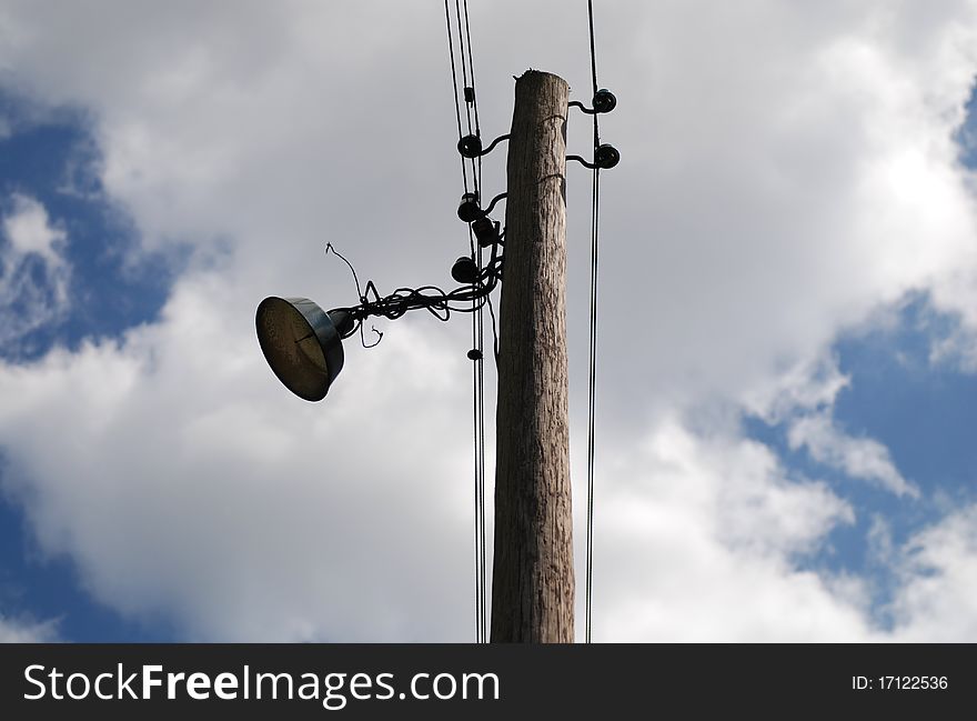 Old vintage street lamp against cloudy sky