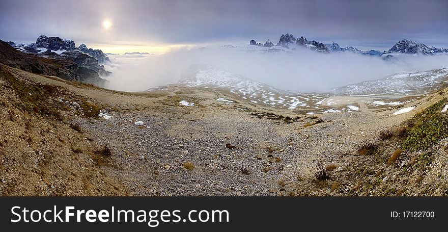 Stitched Panorama, Mountains over the fog in the autumn sunrise, Dolomity, Italy