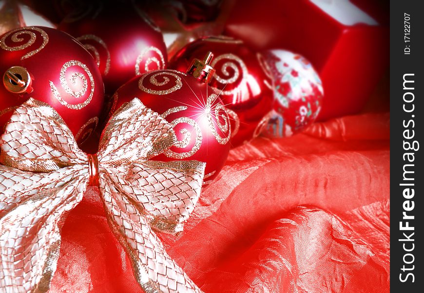 Red present against red background and christmas deco. Red present against red background and christmas deco