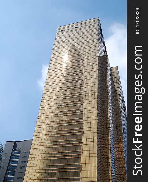 Golden office building with blue sky background in guangzhou city.