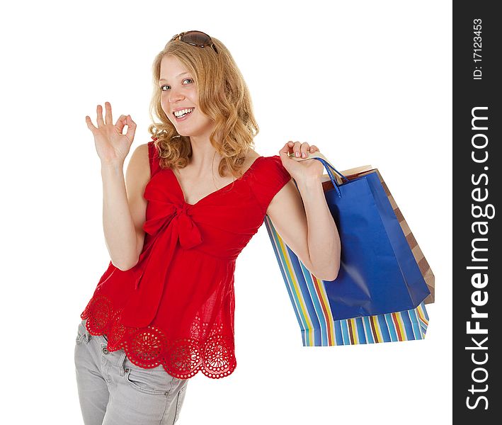 Young girl with purchases on white background