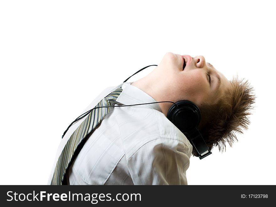 Young boy listening to head phones isolated on white