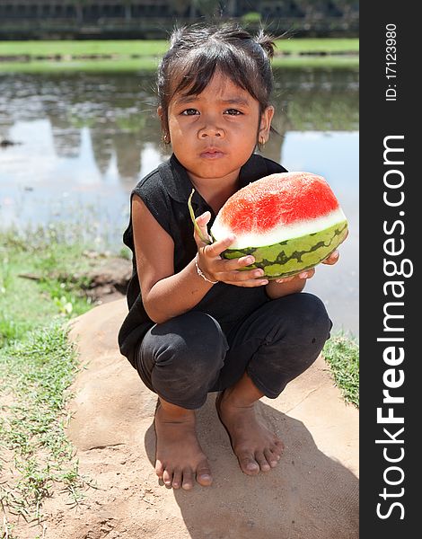 Asian girl with water melon, portrait of child holding fruit