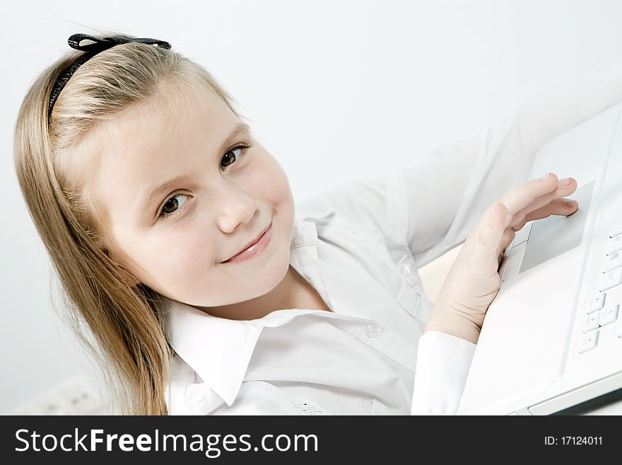 Funny cute girl with a laptop indoors. Funny cute girl with a laptop indoors