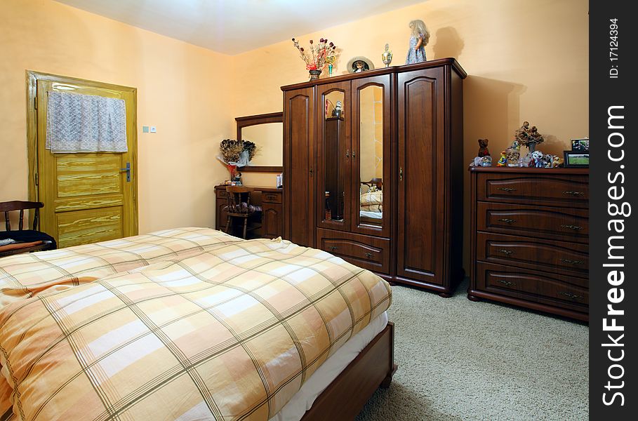 Orange Bedroom with a double wood bed