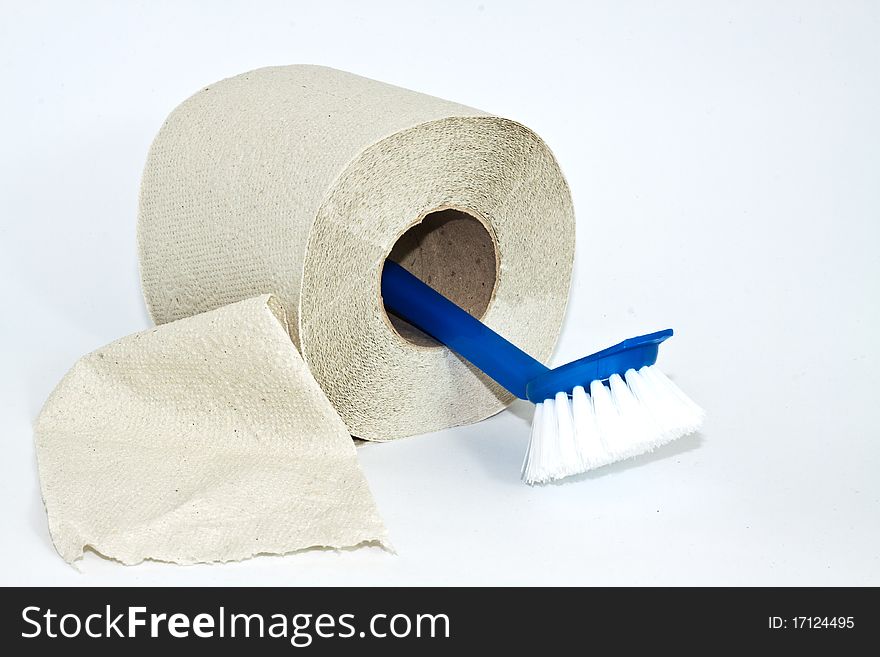 Roll of toilet paper and cleaning brush on a white background. Roll of toilet paper and cleaning brush on a white background