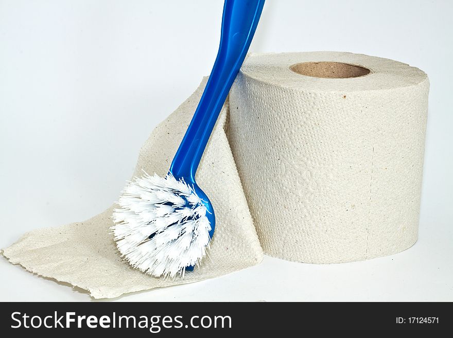 Roll of toilet paper and cleaning brush on a white background. Roll of toilet paper and cleaning brush on a white background