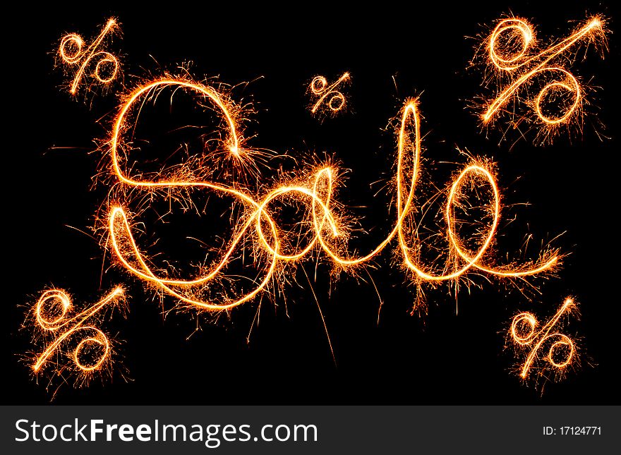 Sparkling inscription of sale on a black background