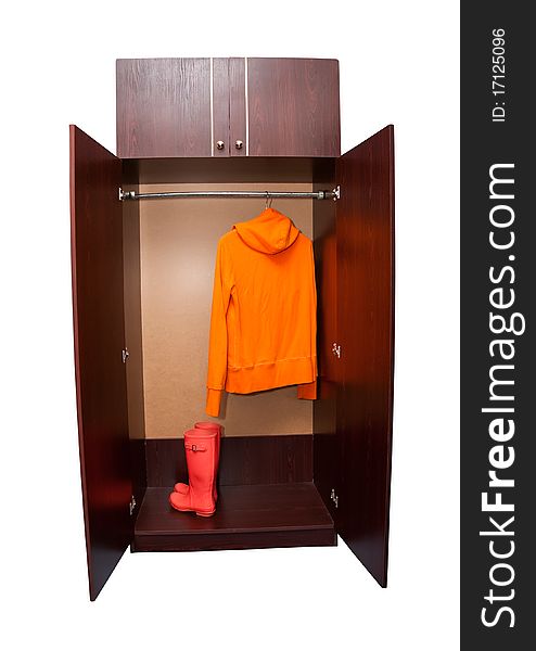 An open cupboard in which the orange boots and raglan