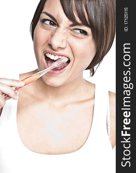 Young happy woman brushing teeth