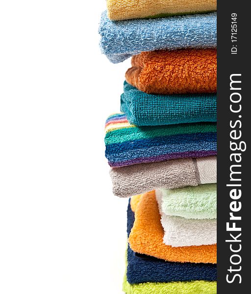 Pile of bright color towels isolated on withe background. Pile of bright color towels isolated on withe background