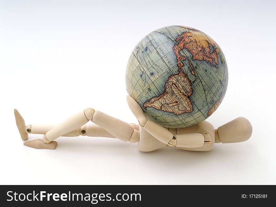 Wooden dummy lying on the chest with a globe. Wooden dummy lying on the chest with a globe