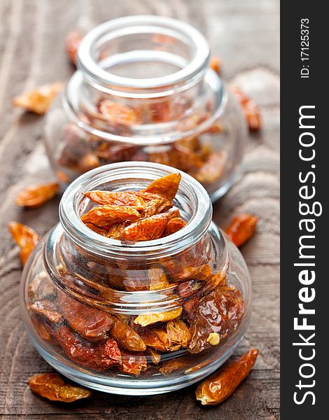 Bird eye chili in a glass on wooden table