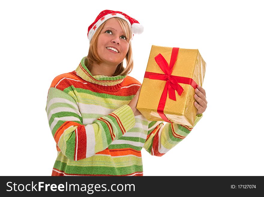 Young woman with santa hat holding a golden christmas gift - isolated. Young woman with santa hat holding a golden christmas gift - isolated