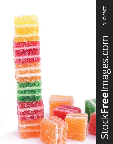 Vertical stack of colorful marmalade candies isolated on white background