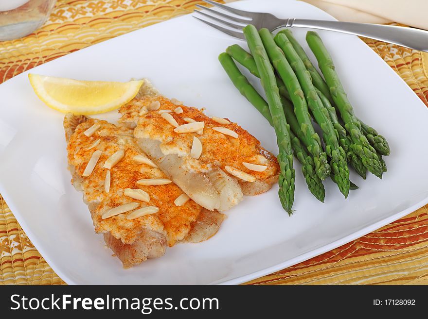 Fish fillet meal with asparagus and a slice of lemon