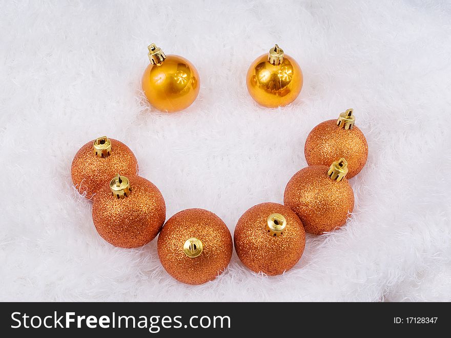 Christmas golden spheres on the white fur. Christmas golden spheres on the white fur