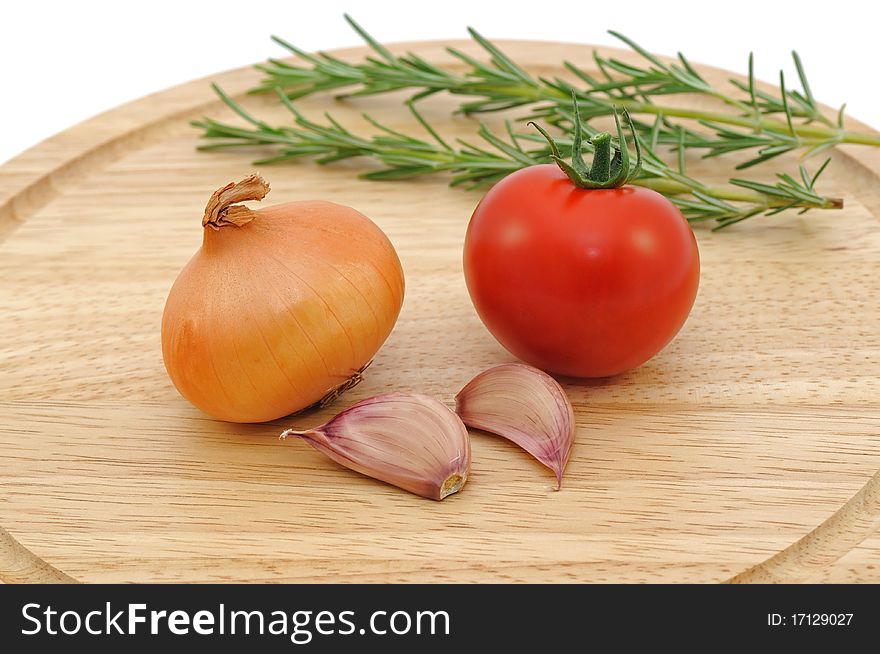 Onion,Garlic cloves and Rosemary on wooden board. Onion,Garlic cloves and Rosemary on wooden board