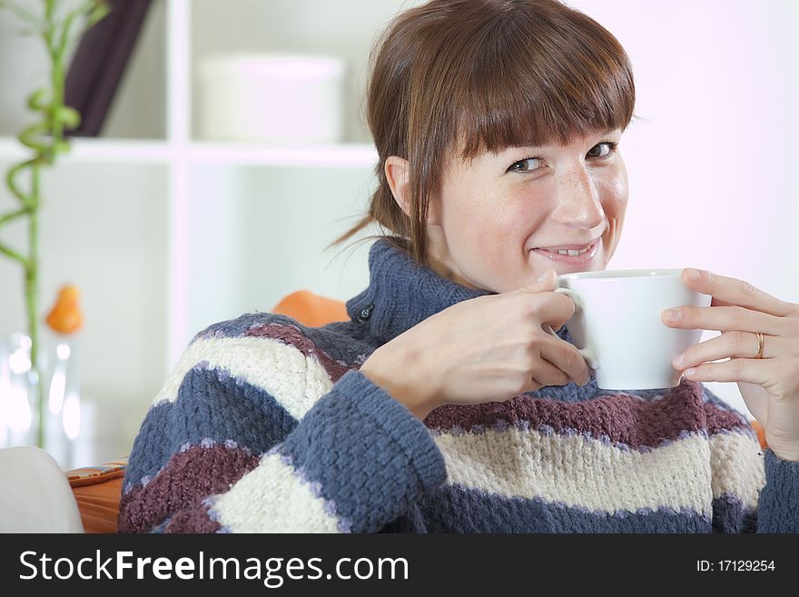 Recreation at home - woman in knit jumper drinking tea. Recreation at home - woman in knit jumper drinking tea