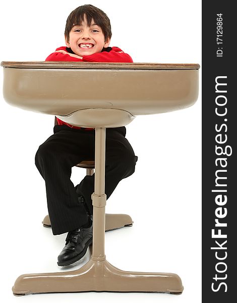 Attractive 7 year old french american boy in school desk over white. Attractive 7 year old french american boy in school desk over white.