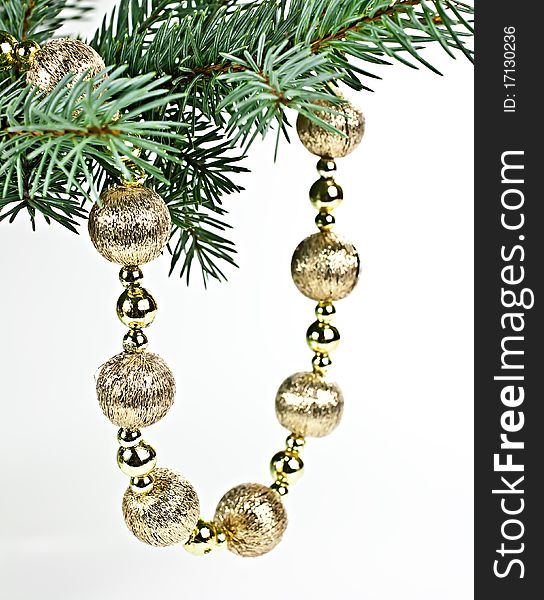 Isolated on a white background with a spruce twig Christmas decorations in a string of bombs. Isolated on a white background with a spruce twig Christmas decorations in a string of bombs.