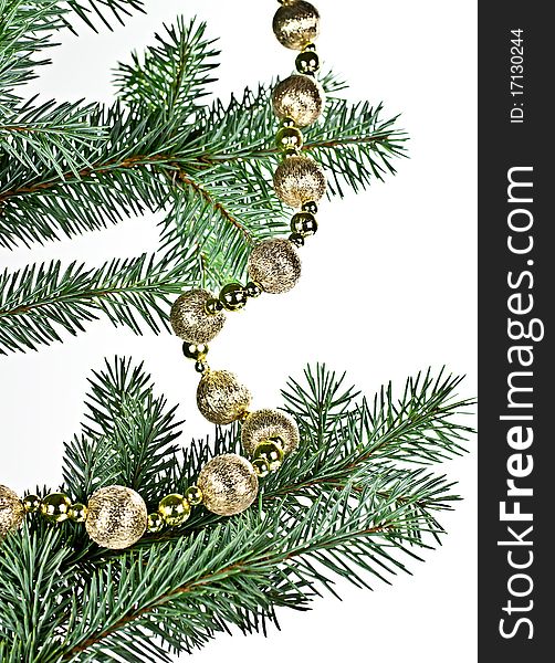 Isolated on a white background with a spruce twig Christmas decorations in a string of bombs. Isolated on a white background with a spruce twig Christmas decorations in a string of bombs.