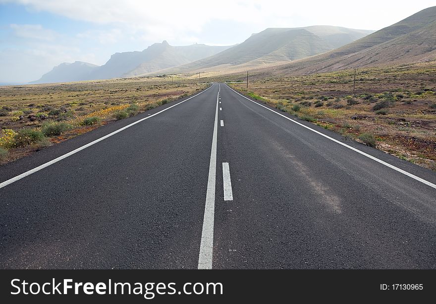 Road with raw and dry landscape, Lanzarote. Road with raw and dry landscape, Lanzarote