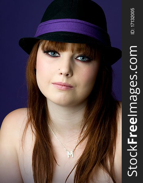 Young model wearing black and purple hat. Young model wearing black and purple hat
