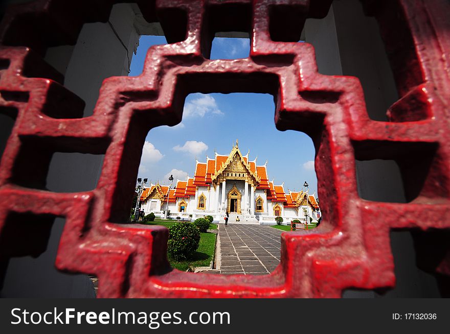 The Marble Temple looked by temple's wall in Bangkok, Thailand. Locally known as Wat Benchamabophit. The Marble Temple looked by temple's wall in Bangkok, Thailand. Locally known as Wat Benchamabophit.