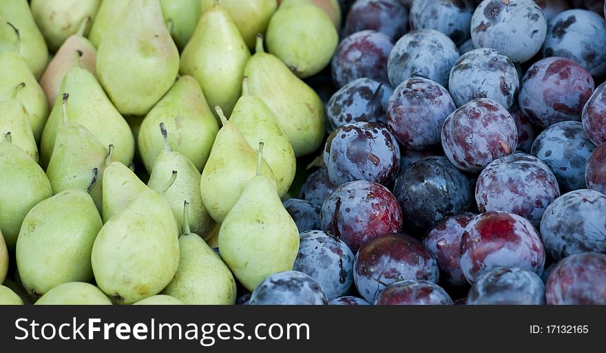 Plums and pears for sale at farmers market in Spain