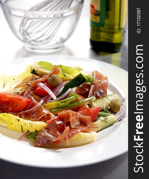Delicious italian style salad with olive oil, parmesan letucce and prosciutto. Delicious italian style salad with olive oil, parmesan letucce and prosciutto