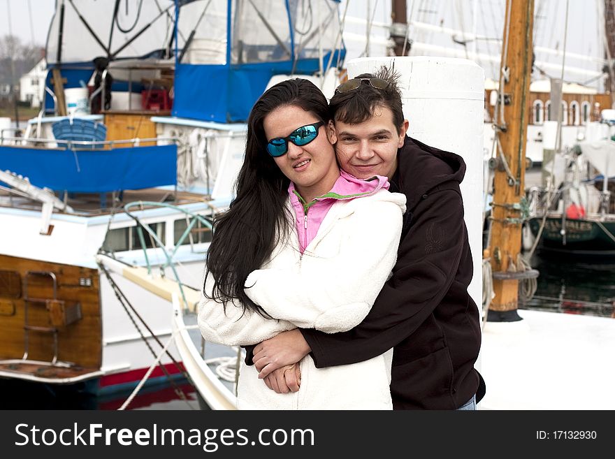 Portrait of a young couple embracing at a pier. Portrait of a young couple embracing at a pier.