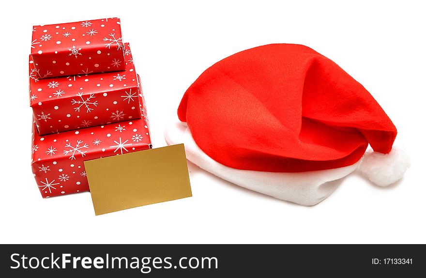 Christmas gift box and red cap on white. Christmas gift box and red cap on white