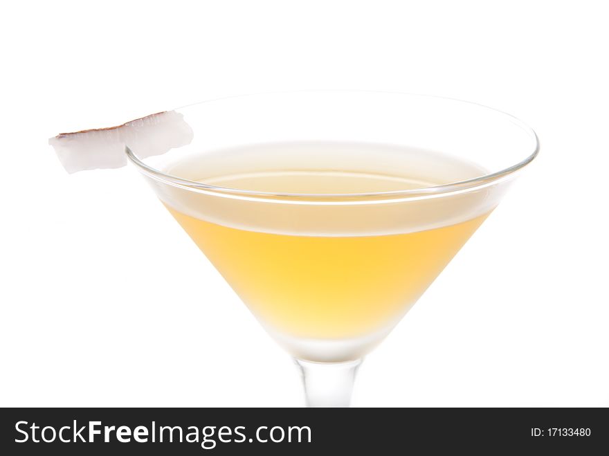 Bella Donna Martini cocktail with dark rum, amaretto, lemon liquor and coconut slice isolated on a white background