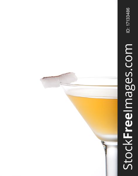 Azure martini cocktail with spiced rum, goldschlager, apple juice, lime and coconut slice isolated on a white background