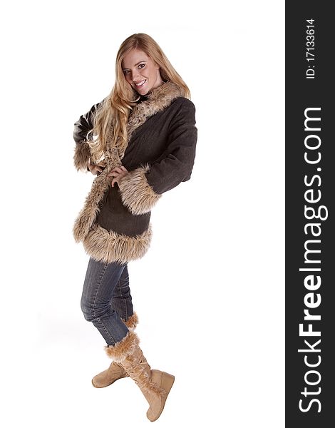 A woman all dressed up in her fuzzy coat and fuzzy boots. A woman all dressed up in her fuzzy coat and fuzzy boots.