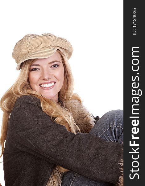 A close up of a woman with a smile while she is wearing a hat and fuzzy coat. A close up of a woman with a smile while she is wearing a hat and fuzzy coat.