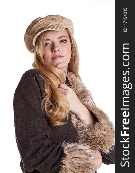 A close up of a woman with a serious expression while she is wearing a hat and fuzzy coat. A close up of a woman with a serious expression while she is wearing a hat and fuzzy coat.