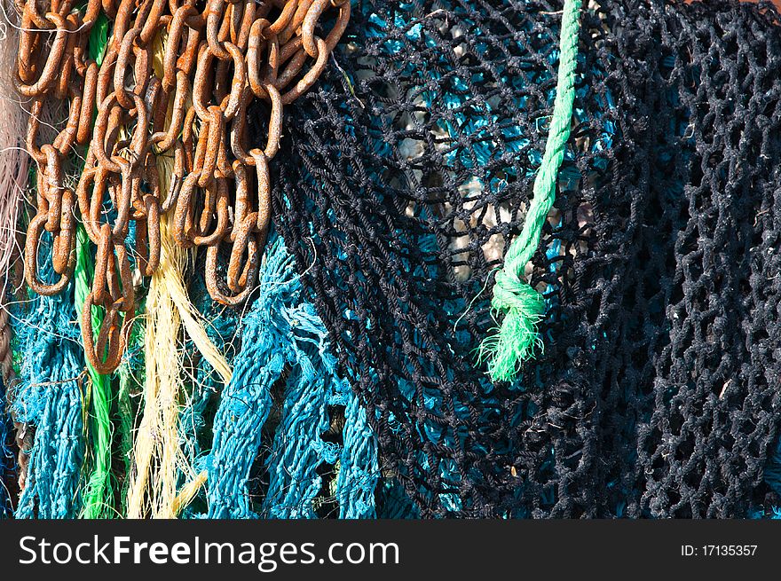 Fishing nets, rope, cord and rusty chain. Fishing nets, rope, cord and rusty chain.