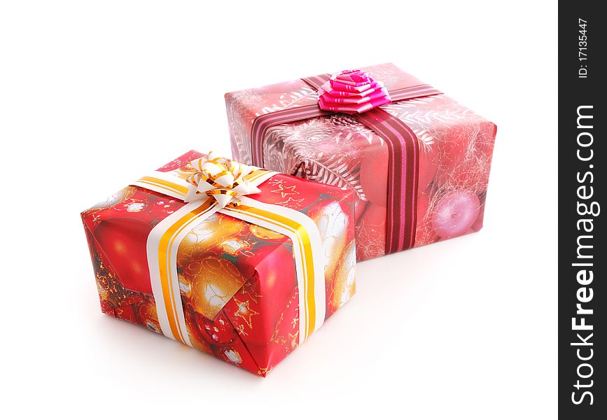 Two Christmas gift boxes decorated with colorful ribbons isolated on white