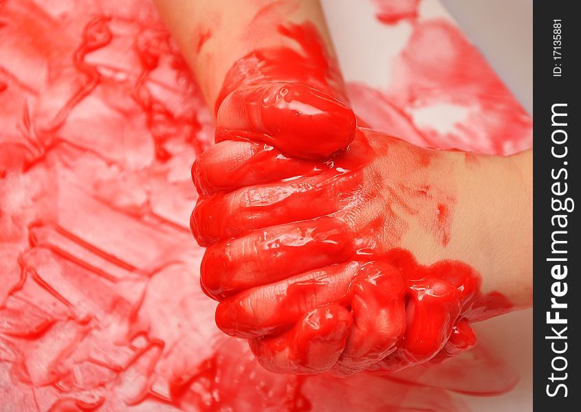 Child Hands Painted In Red Paint