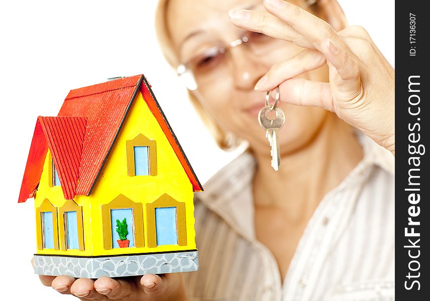 Female hands holding concept house. Selective focus on the house. Female hands holding concept house. Selective focus on the house