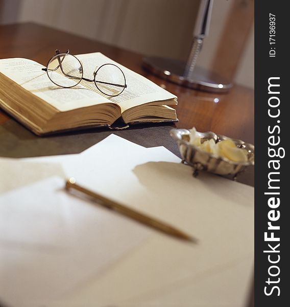 Ancient paper and book on antique wooden table -