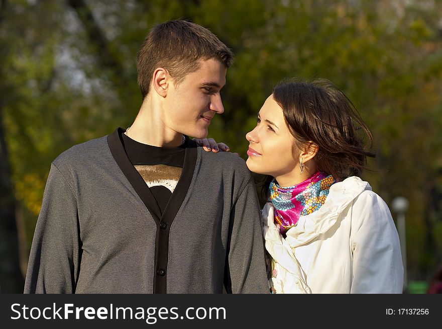 Young couple looking at each other eyes over defocused background. Young couple looking at each other eyes over defocused background