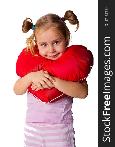 Beautiful girl with heart shaped pillow isolated on white