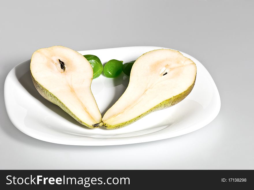 Two half of pear n a white plate