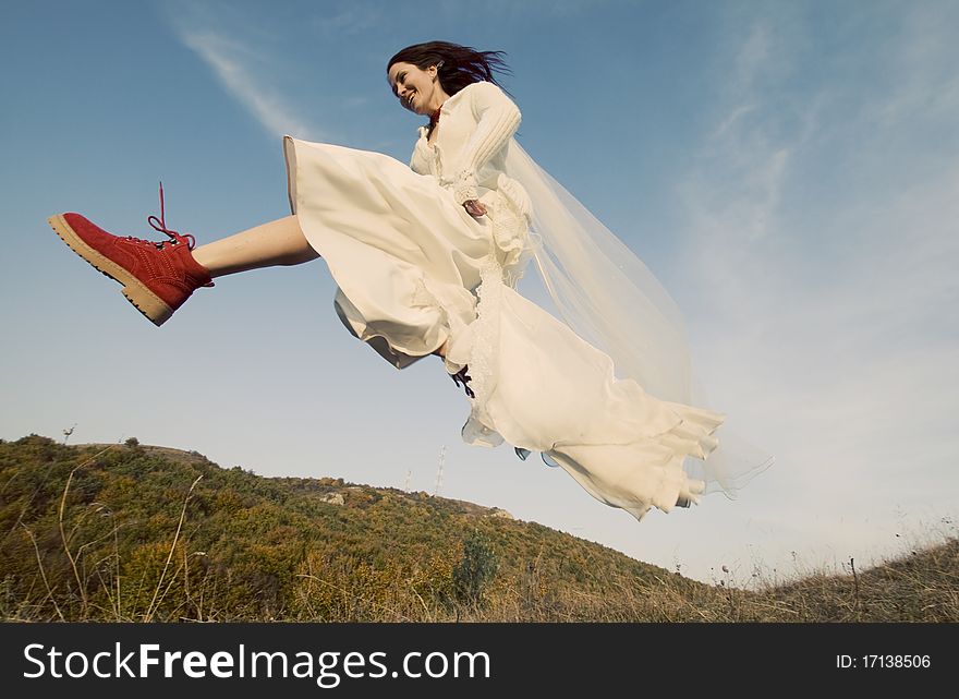 Portrait of romantic woman jumping on field. Portrait of romantic woman jumping on field