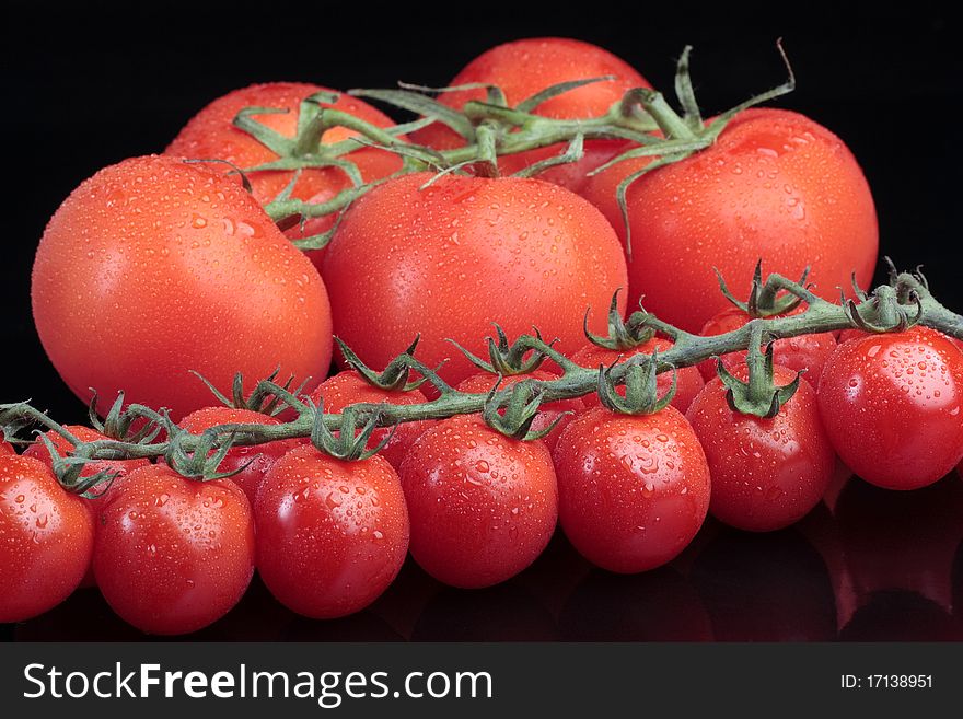 Cherry tomatoes over black background