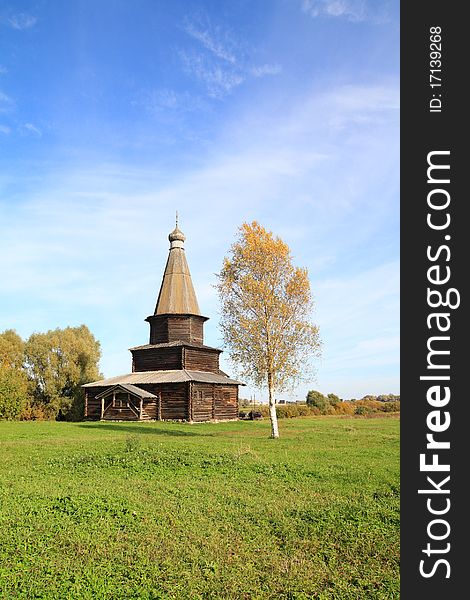 Wooden chapel on green field